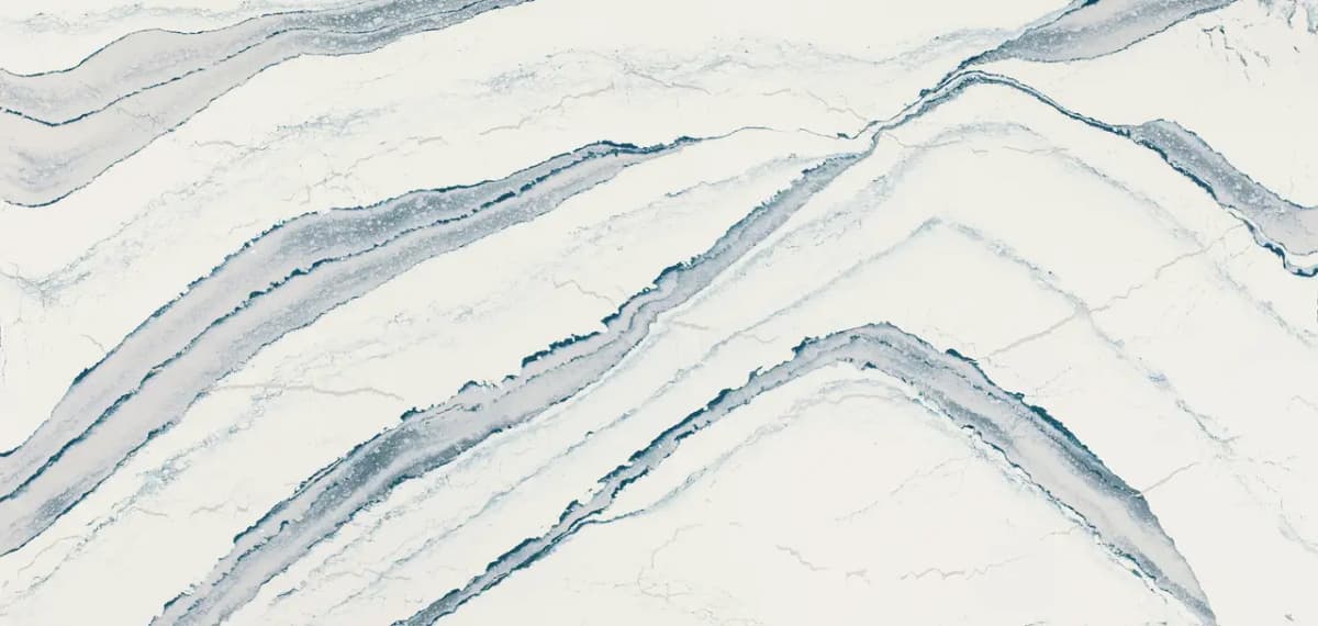 Stormy-blue waves surge against the cool white backdrop of this striking design, cloaking its translucent gray colorways with soft ripples and pronounced spires of saturated cobalt, paired with delicate debossed Inverness™ veins, adding subtle texture.