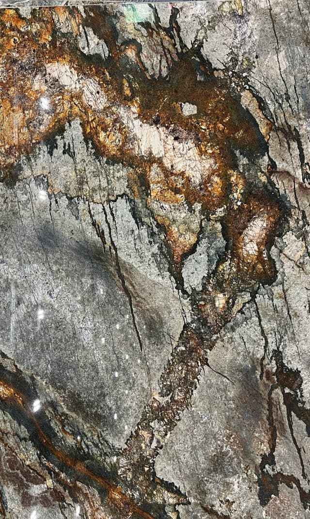 White and copper granite with green and gray linings.