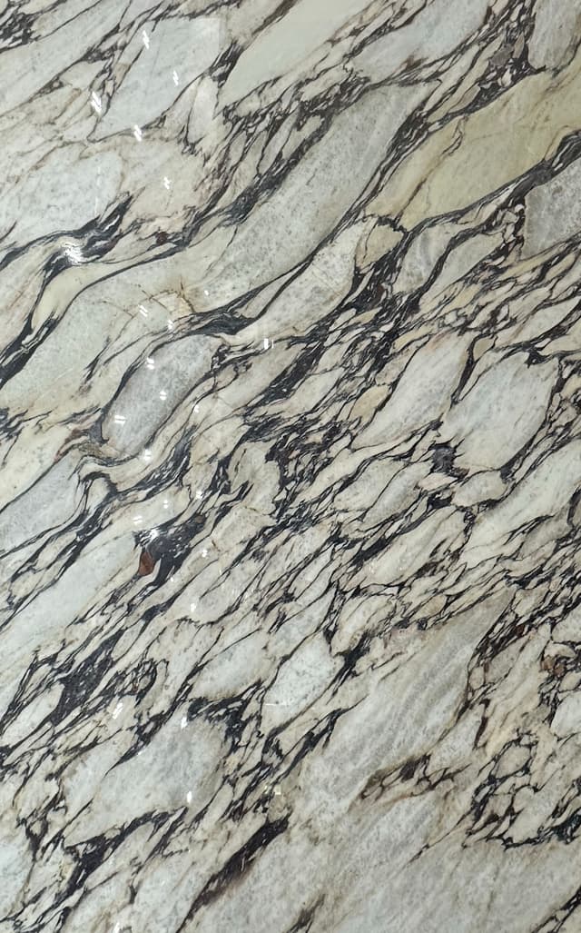 White marble with red-copper and gray veining.