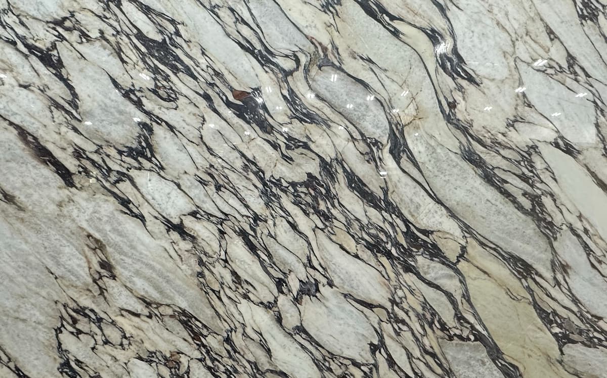 White marble with red-copper and gray veining.