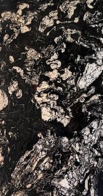 Black granite slab with gray, silver and gold swirl pattern