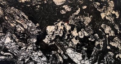 Black granite slab with gray, silver and gold swirl pattern