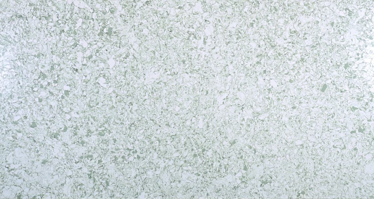 A white slab with a green glaze, translucent with ranges in colors from pale to grayish-green in a refined pattern.