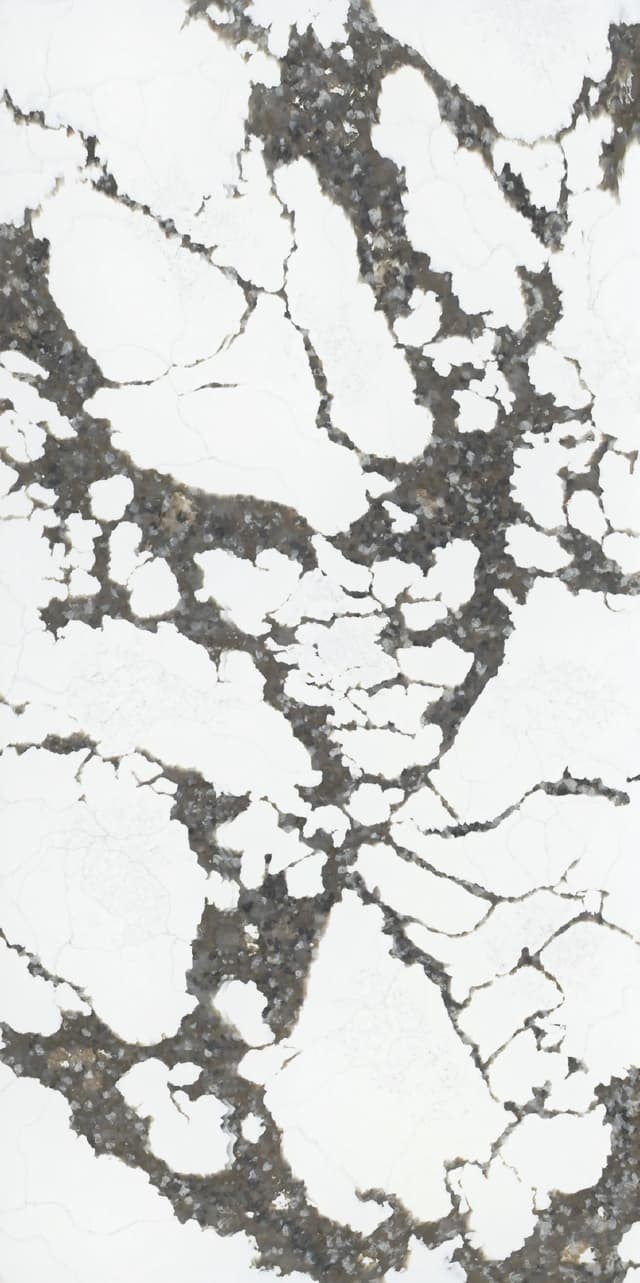 A warm quartz slab with a cream colored base with bold beige veins