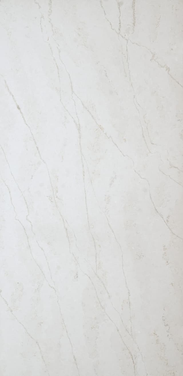 The Elara quartz slab embodies a harmonious fusion of celestial beauty in soft whites and silvery grey veins. Resembling the natural veining found in marble, these formations are distinct and a perfect compliment to several installation applications.