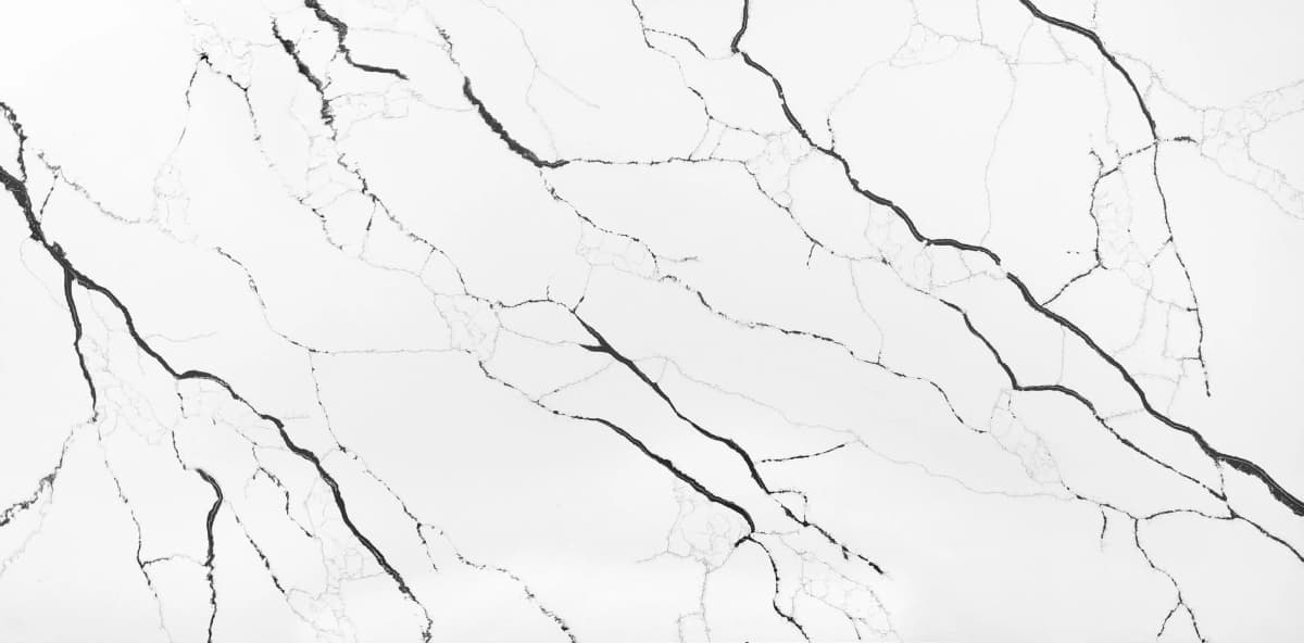 Introducing the Lux Noir quartz slab, evoking a sense of mystery and sophistication. Profound veins of silver and charcoal weave through the slab creating an interplay of light and darkness.